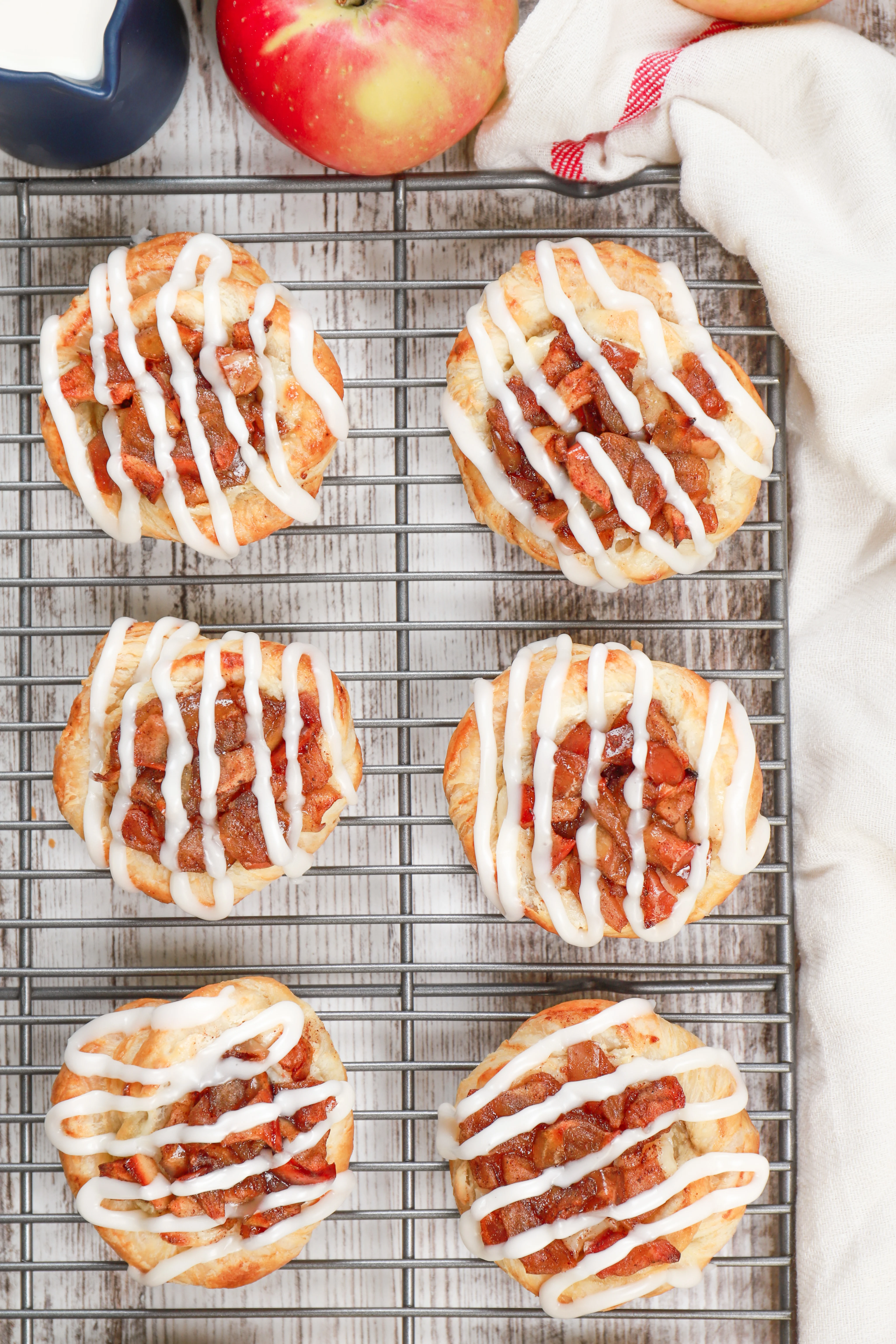 above view of apple cream cheese danishes on a wire cooling rack