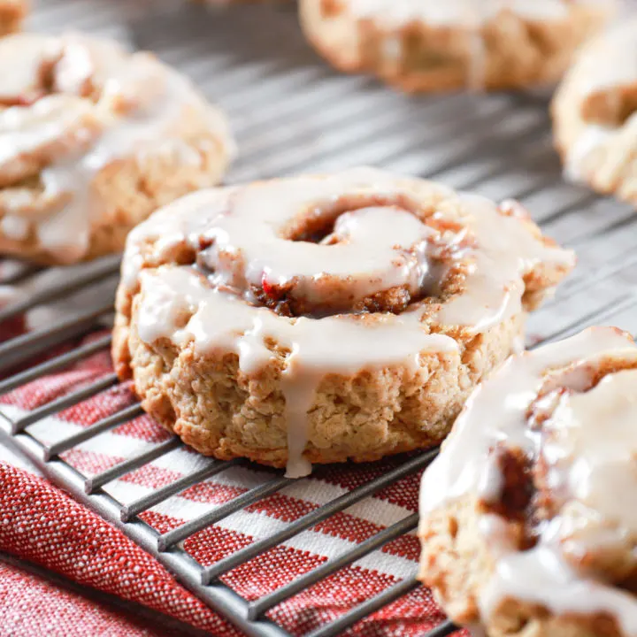 Side view of an apple cinnamon roll scone on a cooling rack