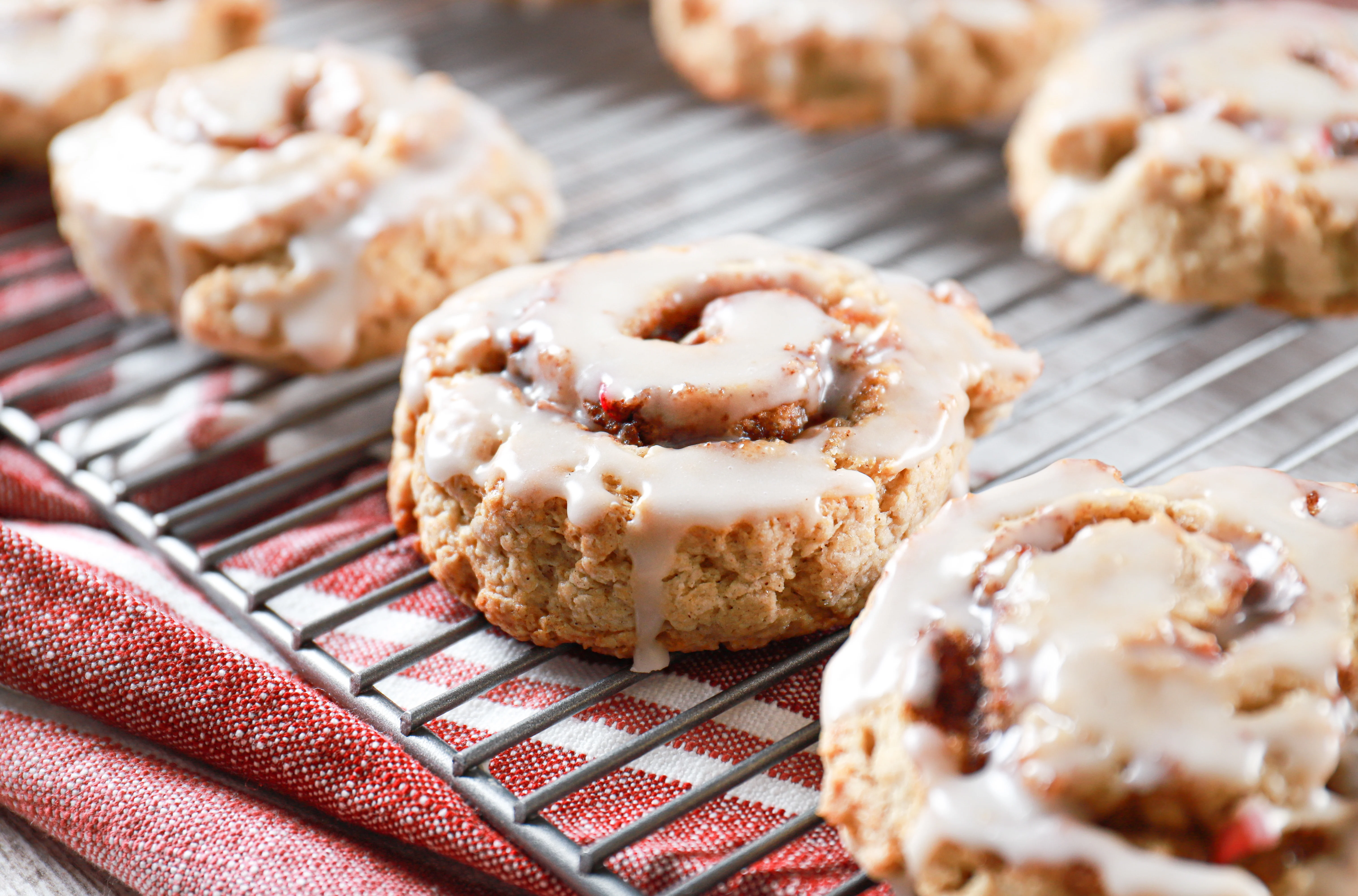 Side view of an apple cinnamon roll scone on a cooling rack