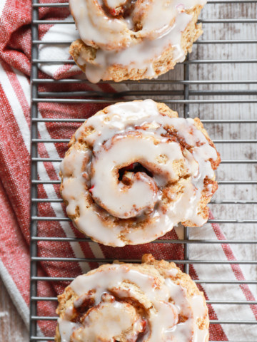 Overhead view of an apple cinnamon roll scone on a cooling rack