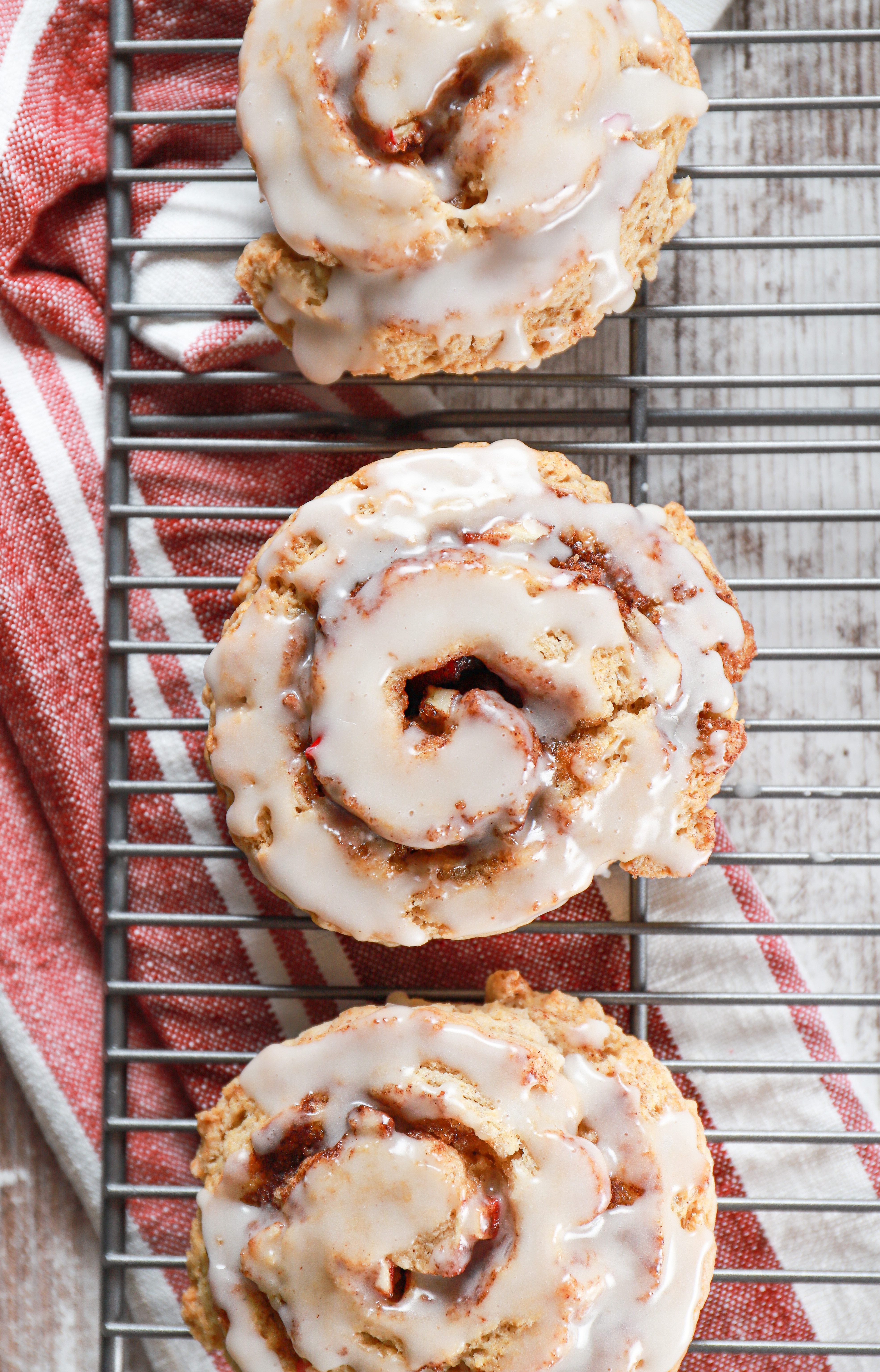 Overhead view of an apple cinnamon roll scone on a cooling rack