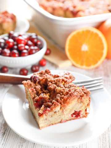 Slice of cranberry orange french toast bake on a small white plate.