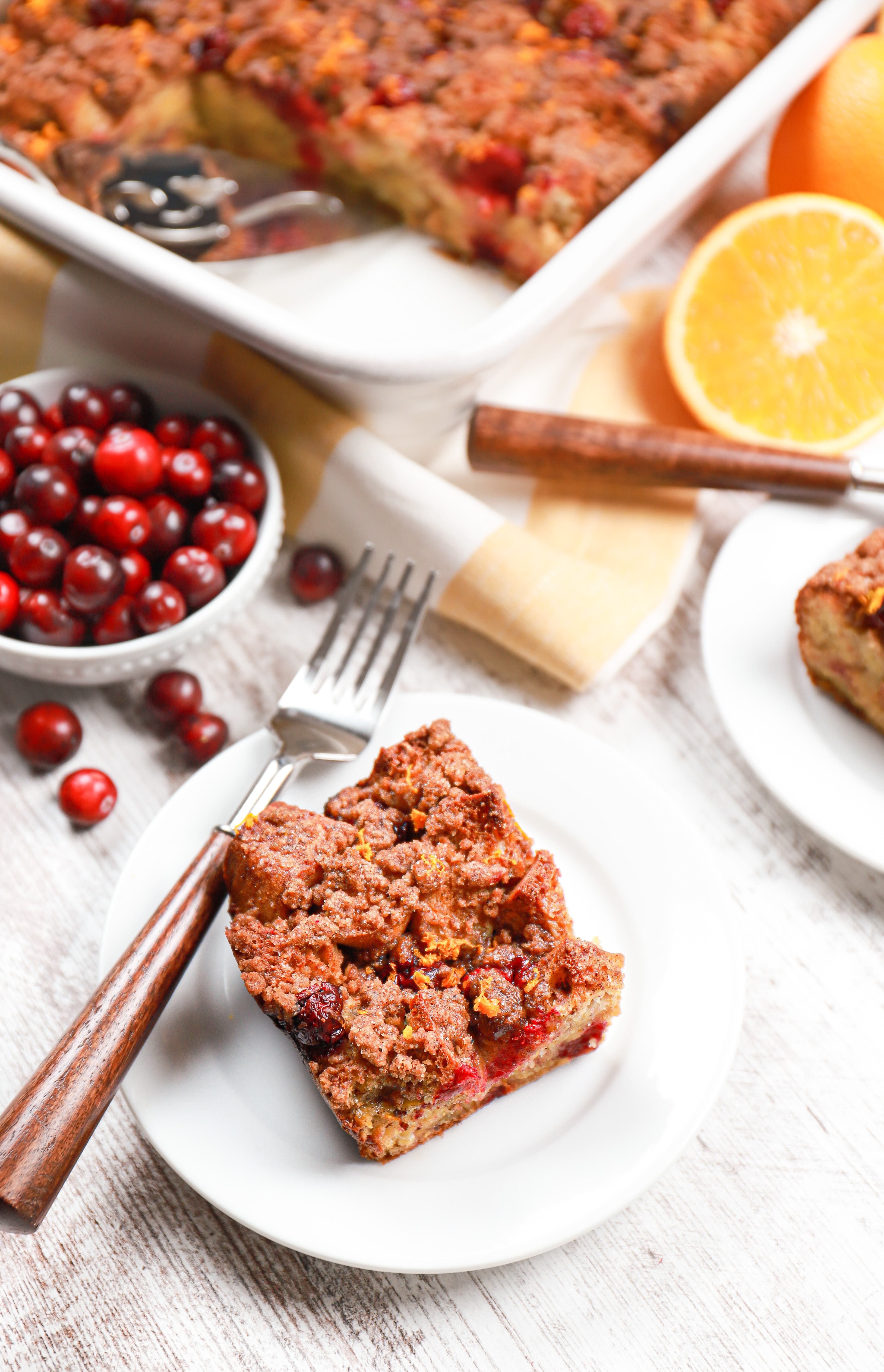 https://www.a-kitchen-addiction.com/wp-content/uploads/2021/11/cranberry-orange-french-toast-bake-vert-angle-with-piece.jpg