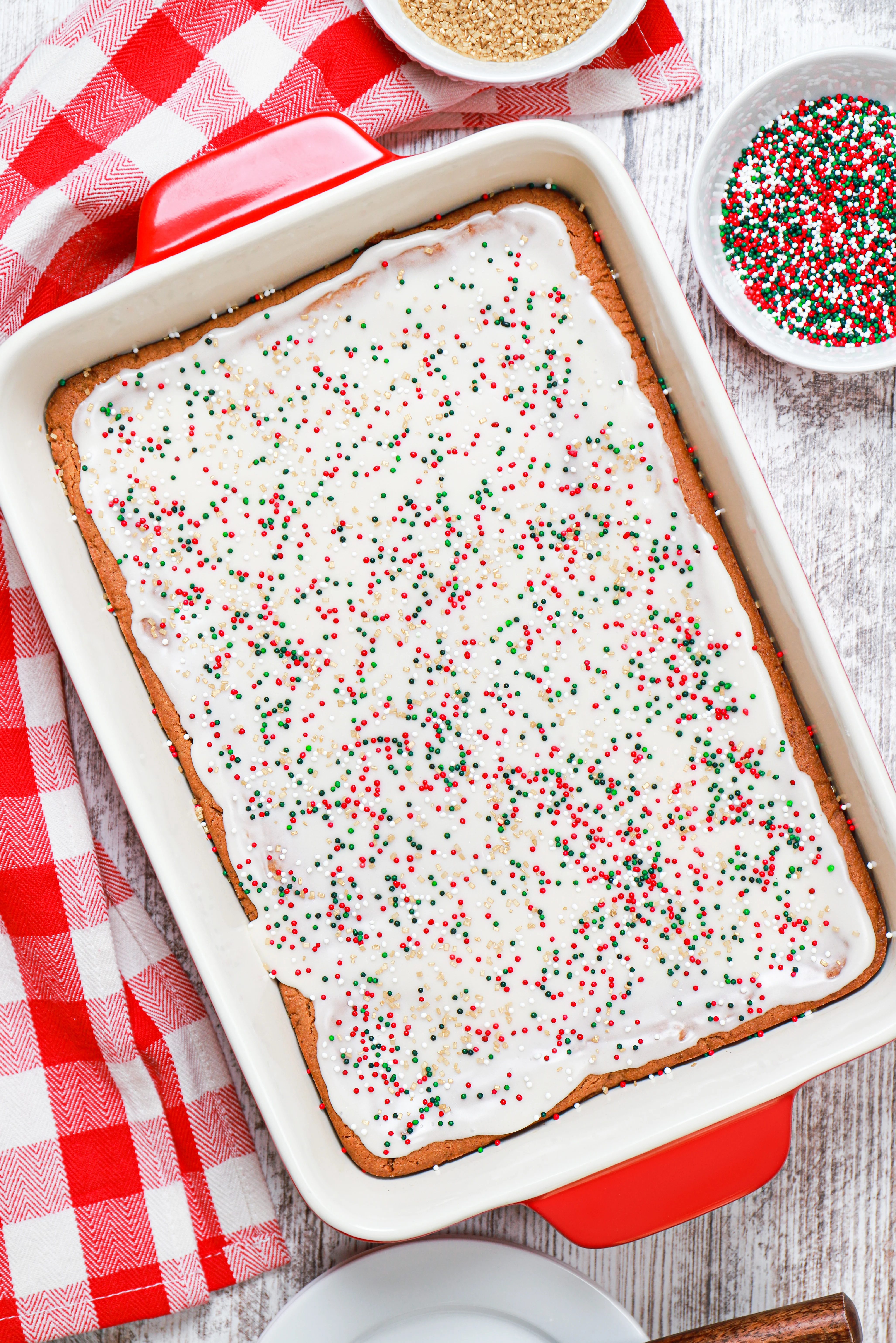 Overhead view of a red baking dish full of glazed gingerbread bars.