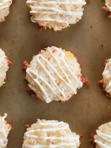 Up close overhead view of a white chocolate drizzled pineapple coconut macaroon.