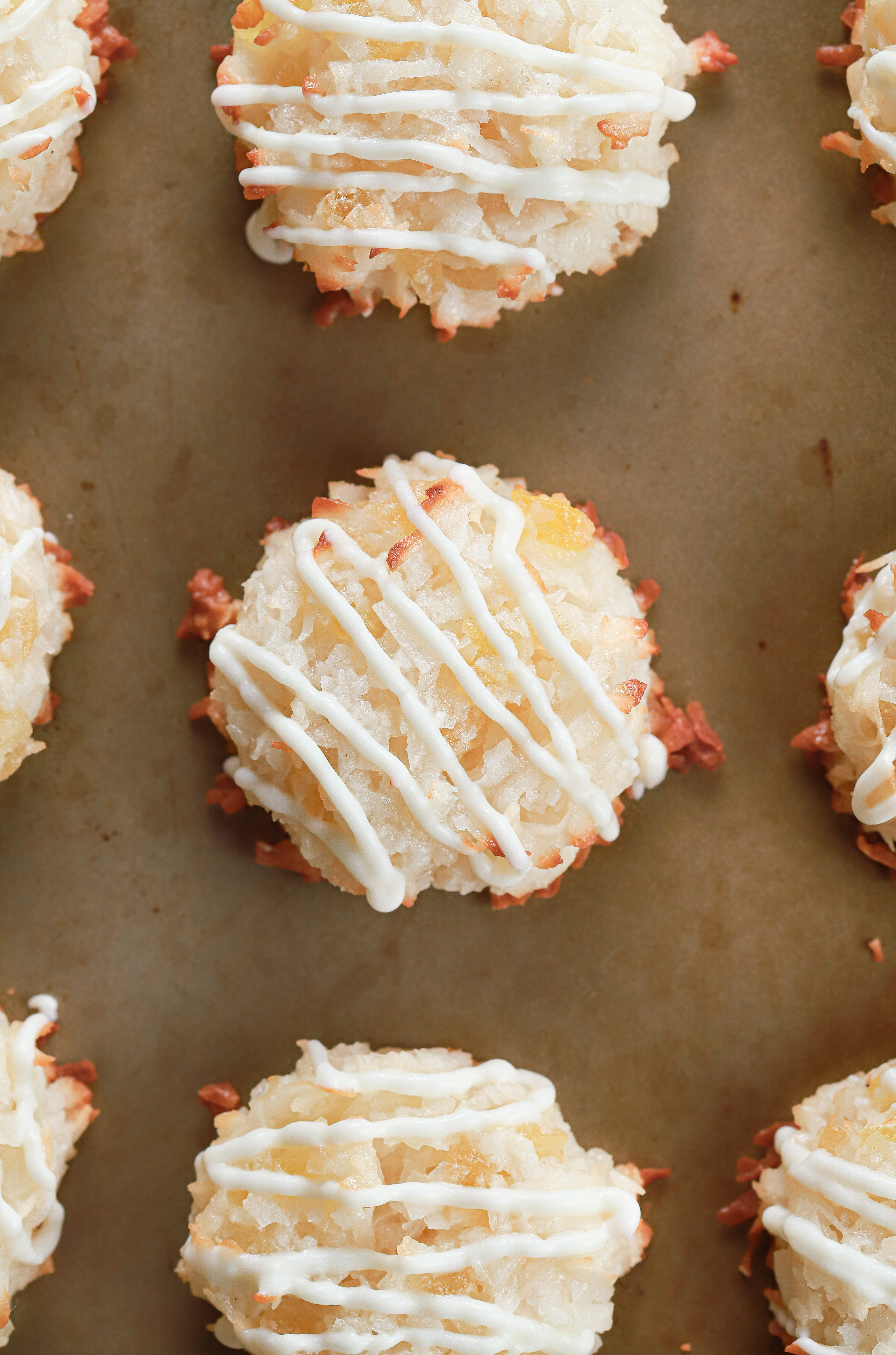 Up close overhead view of a white chocolate drizzled pineapple coconut macaroon.