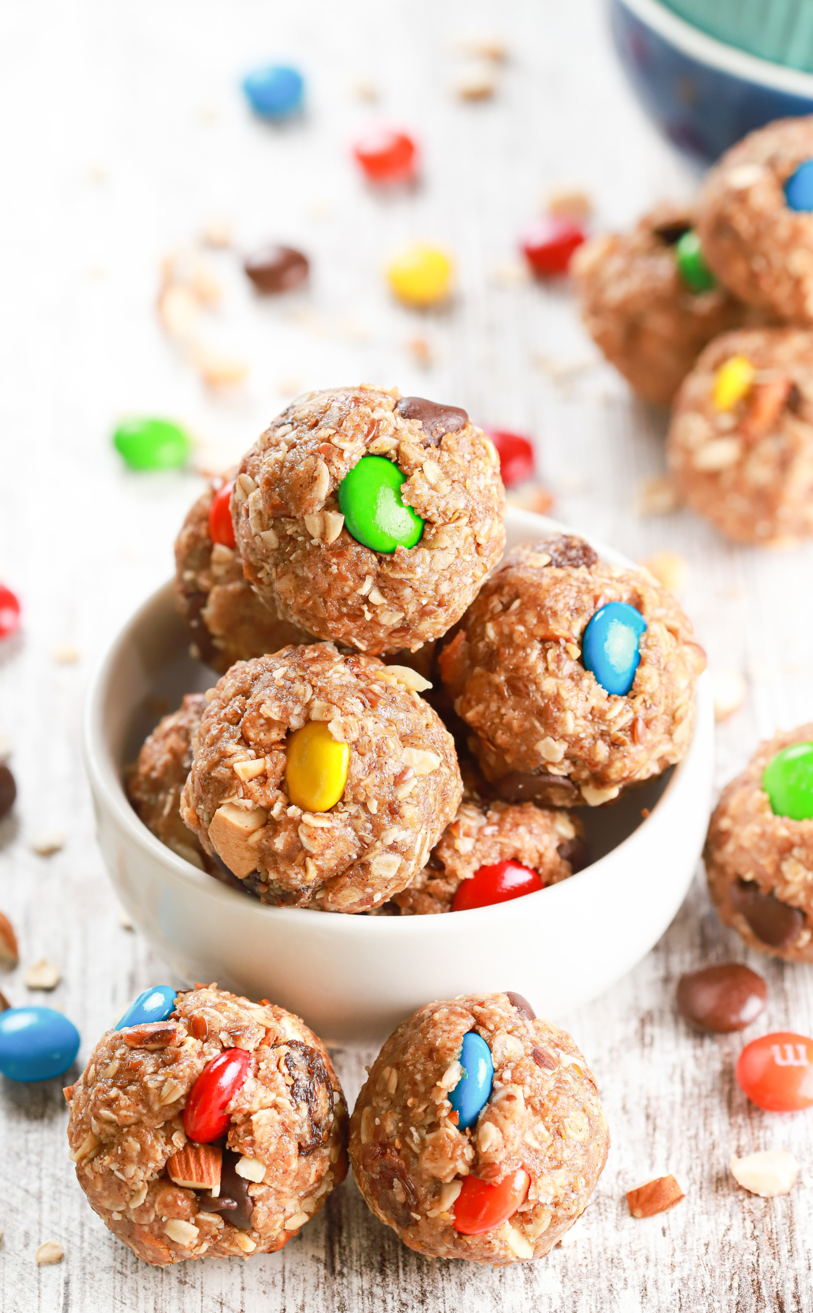 Up close overhead view of a small white bowl full of almond butter trail mix bites.