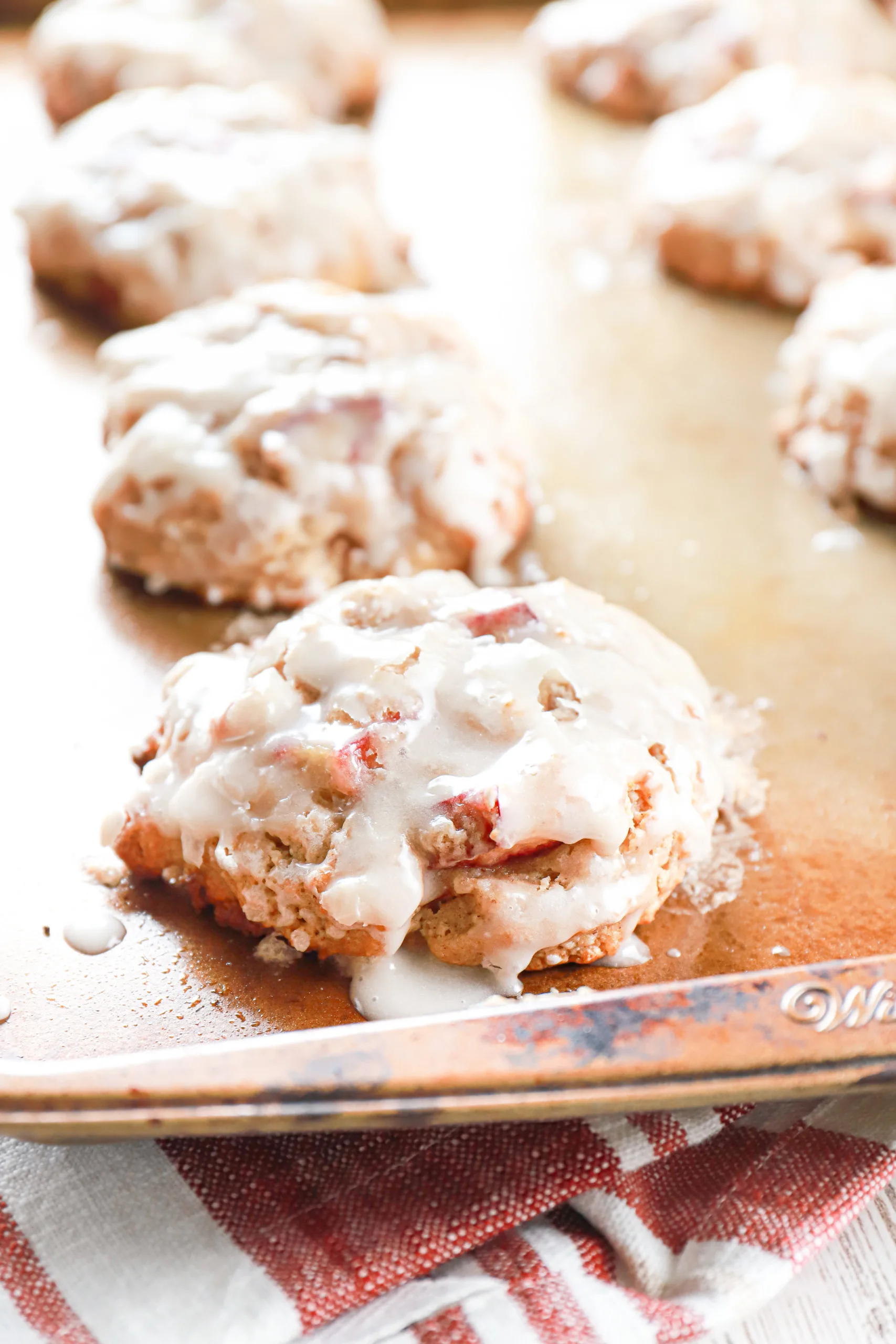 Side view of a baked rhubarb fritter on an aluminum baking sheet.