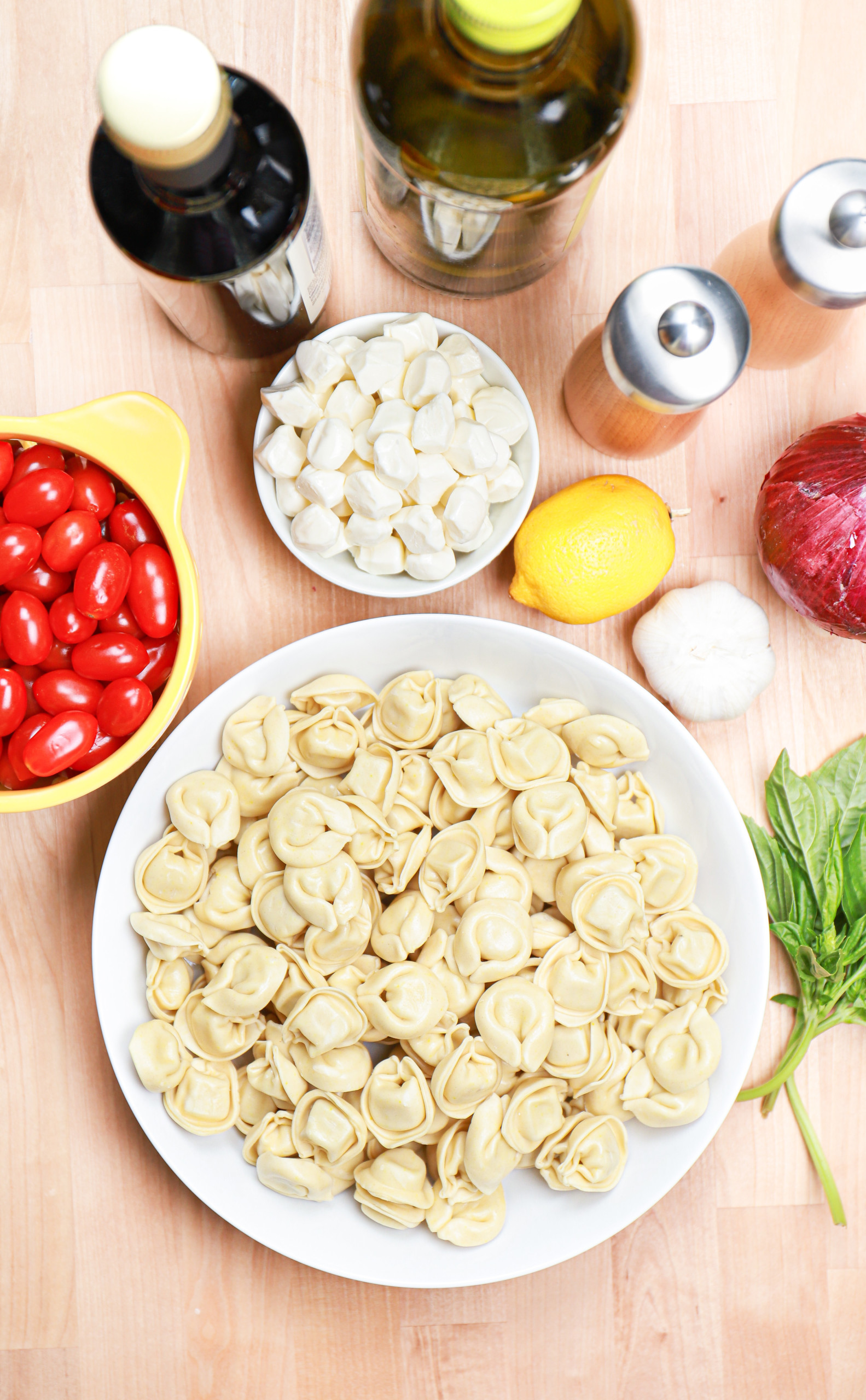 Overhead view of the ingredients for caprese tortellini salad.