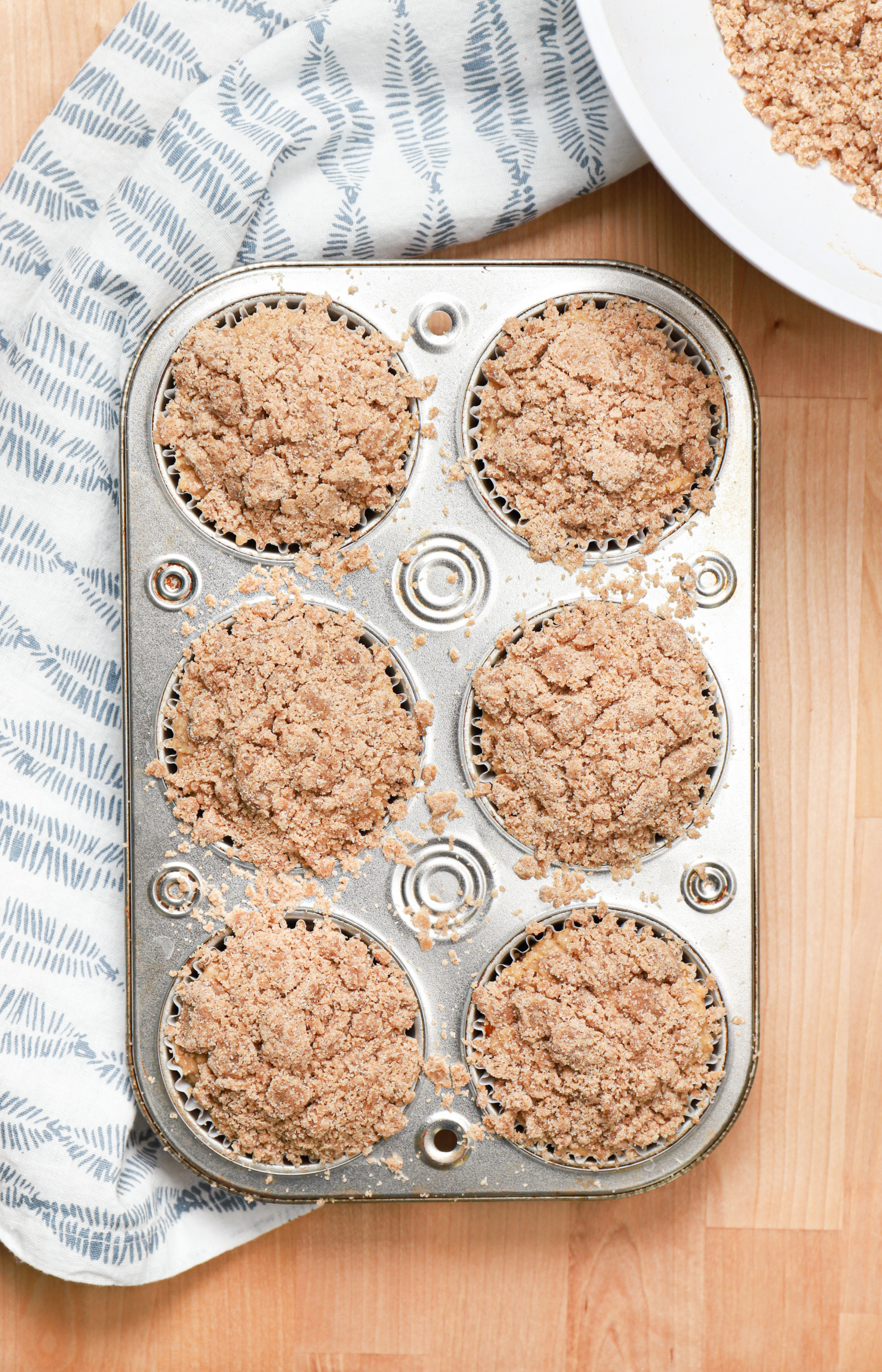 Overhead view of peach coffee cake muffins before baking.