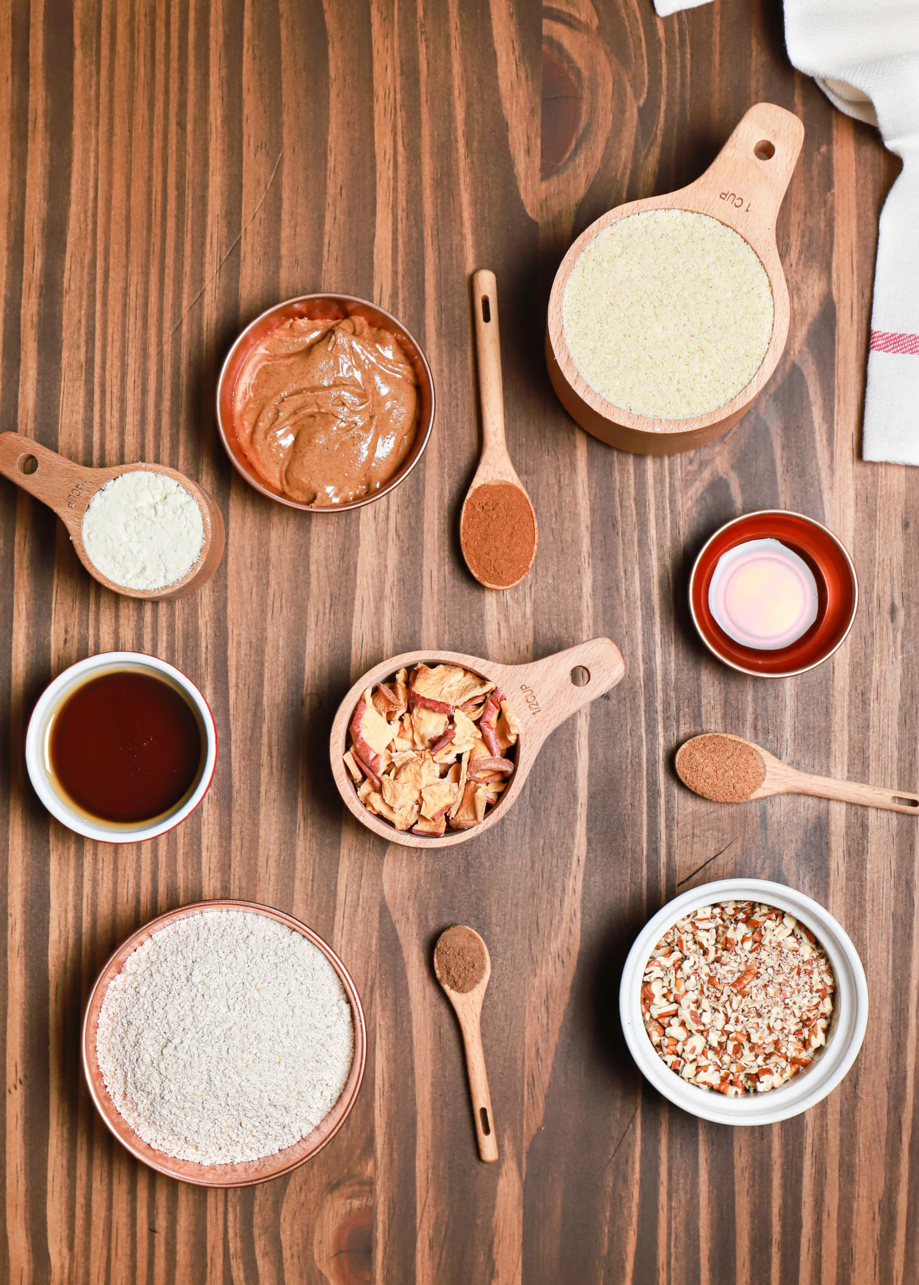 Overhead view of apple pie protein bite ingredients on a wooden board.