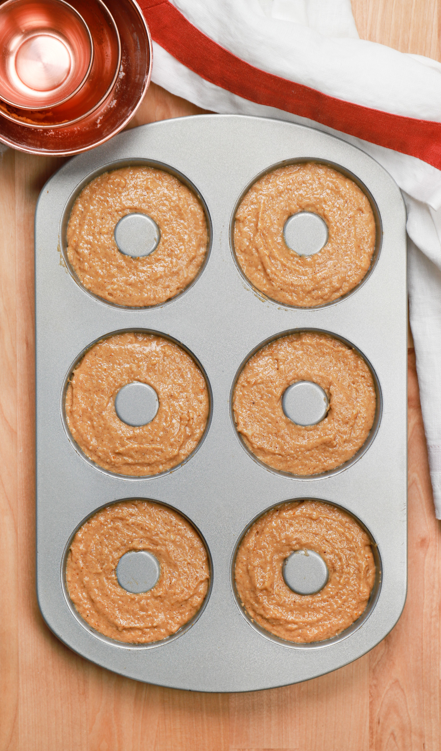 Overhead view of the cinnamon sugar pumpkin donut batter in the donut pan/