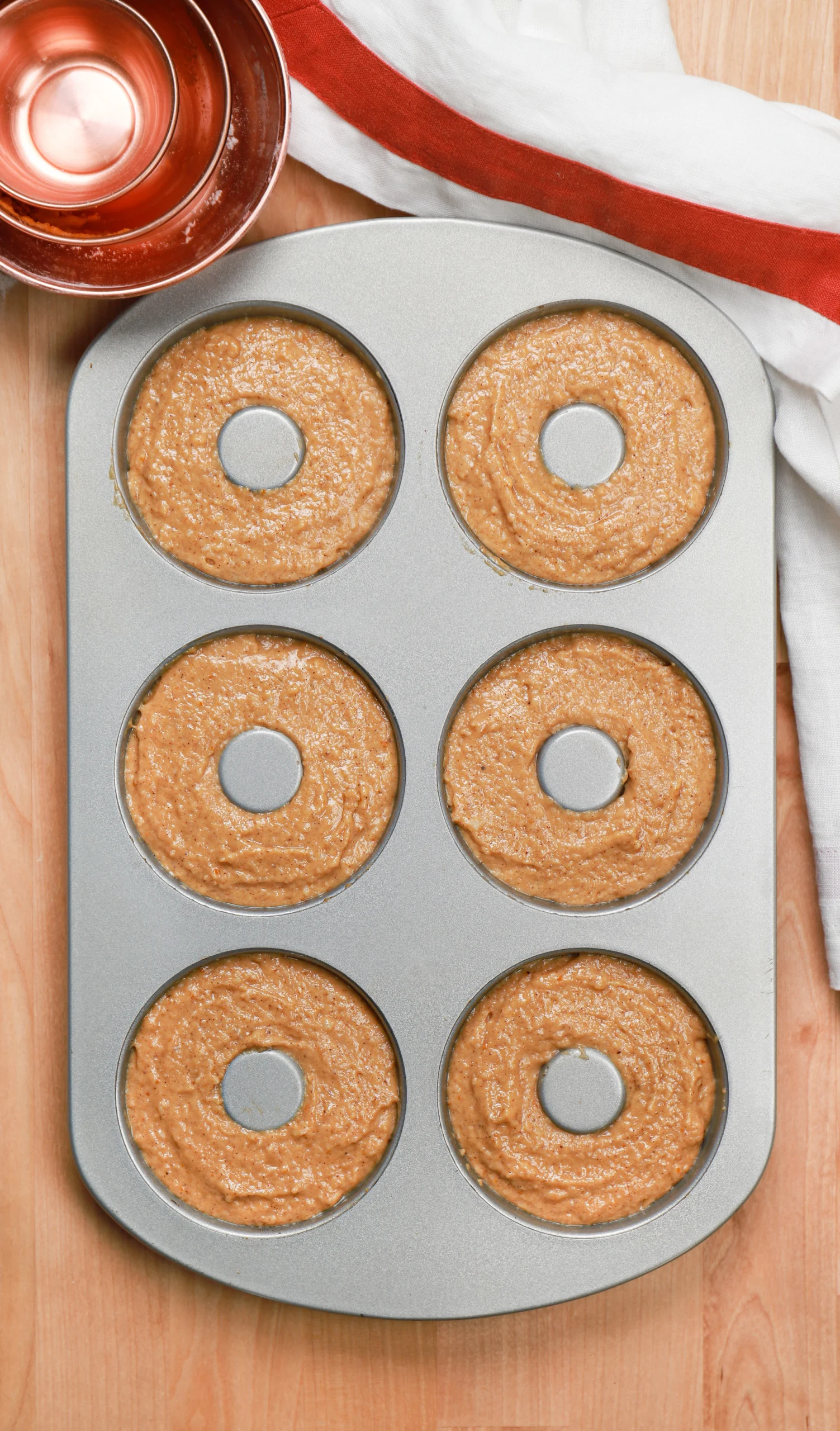 Overhead view of the cinnamon sugar pumpkin donut batter in the donut pan/