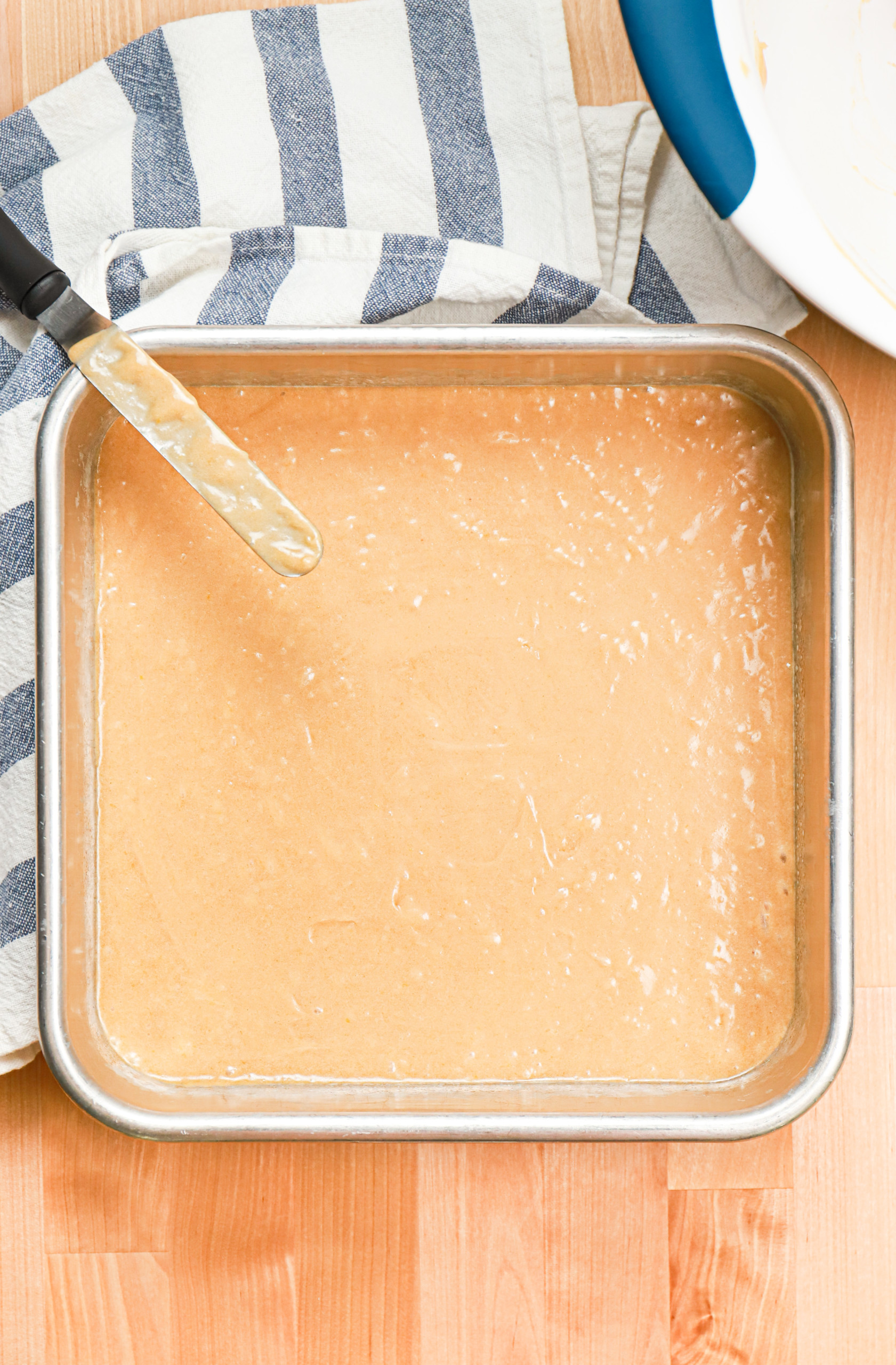 Overhead view of the maple blondie batter in an aluminum baking dish.