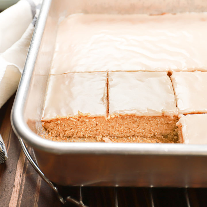 Cut maple blondies in an aluminum baking dish atop a wire cooling rack,