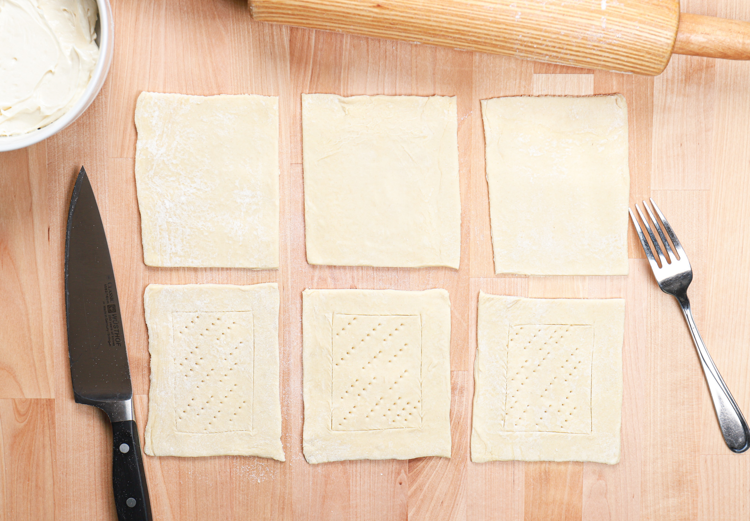 Overhead view of the puff pastry base scored and ready for the filling.