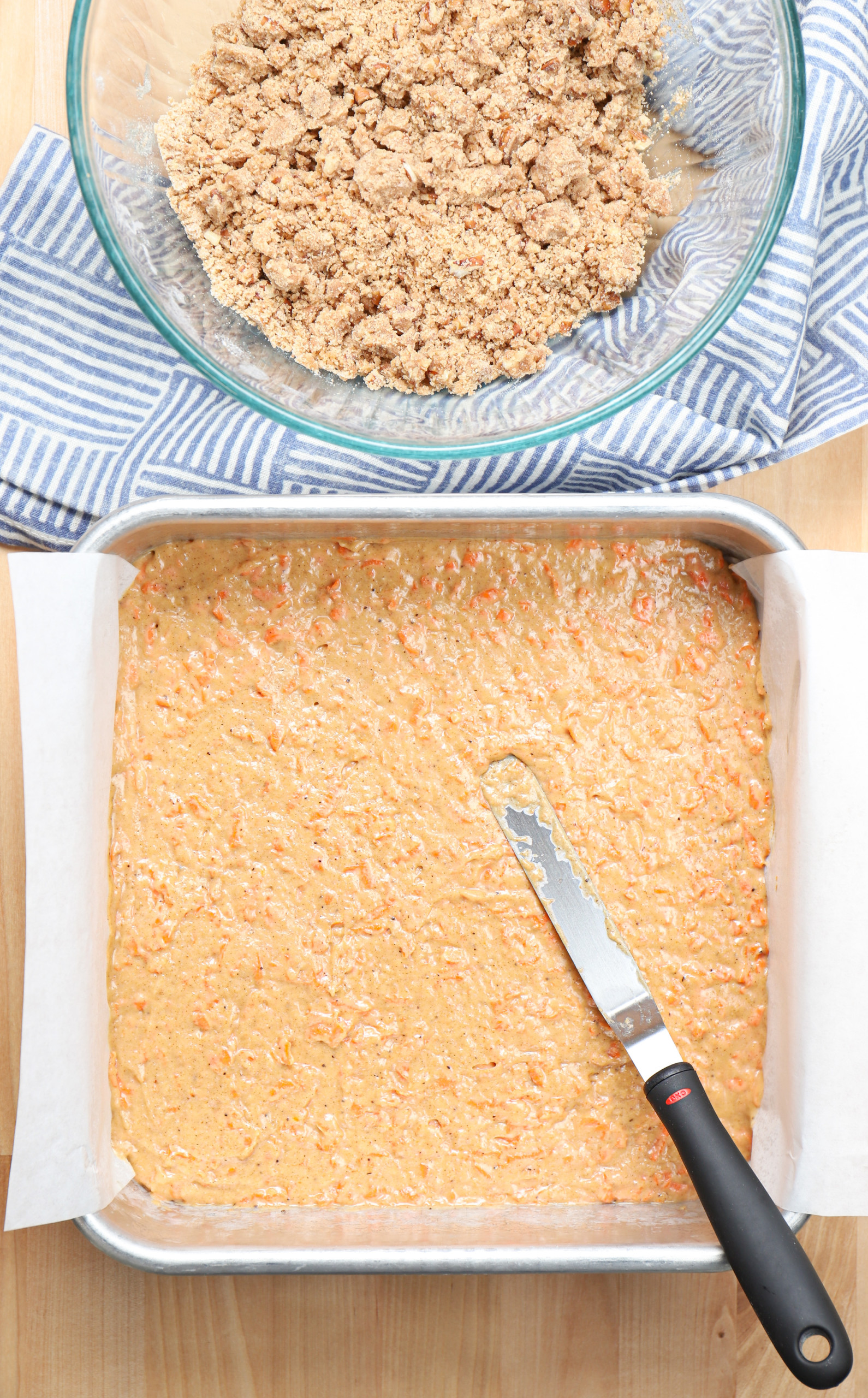 Overhead view of a pan of carrot cake coffee cake batter before the streusel topping.