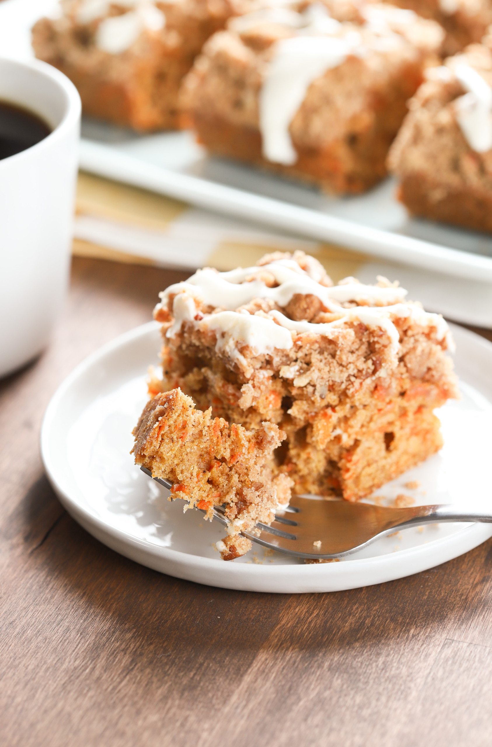 Up close view of a bite of carrot coffee cake on a fork.