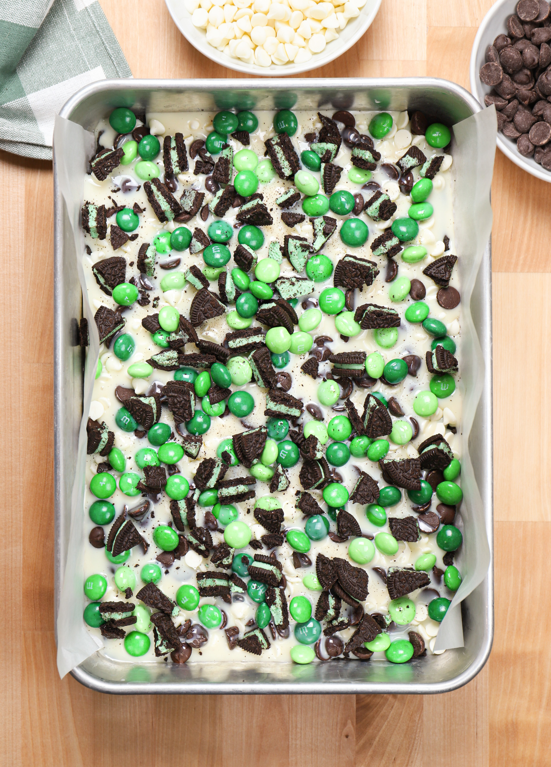 Overhead view of a batch of mint chocolate seven layer bars before they are baked.