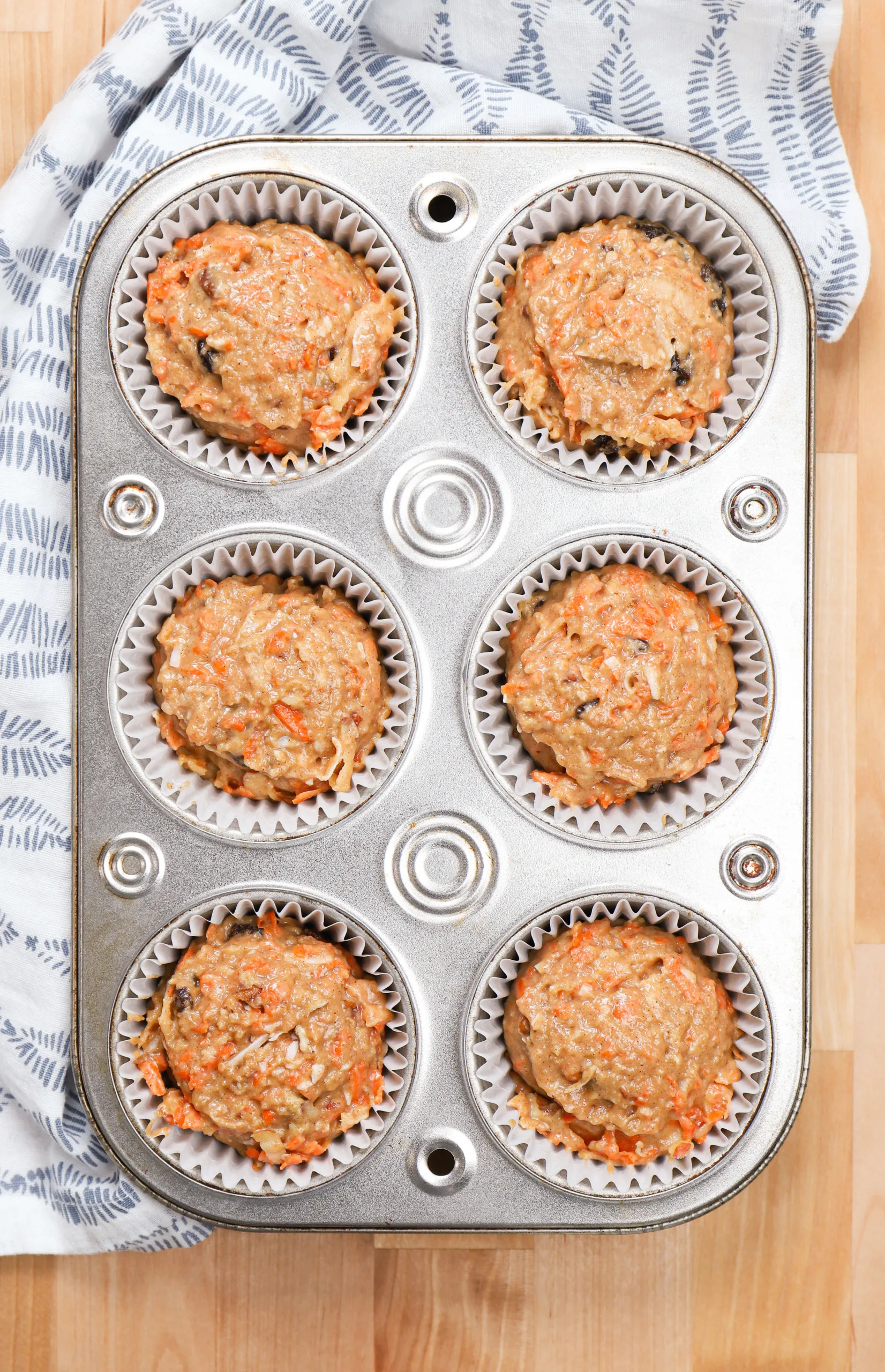 Overhead view of a batch of morning glory muffins before baking.