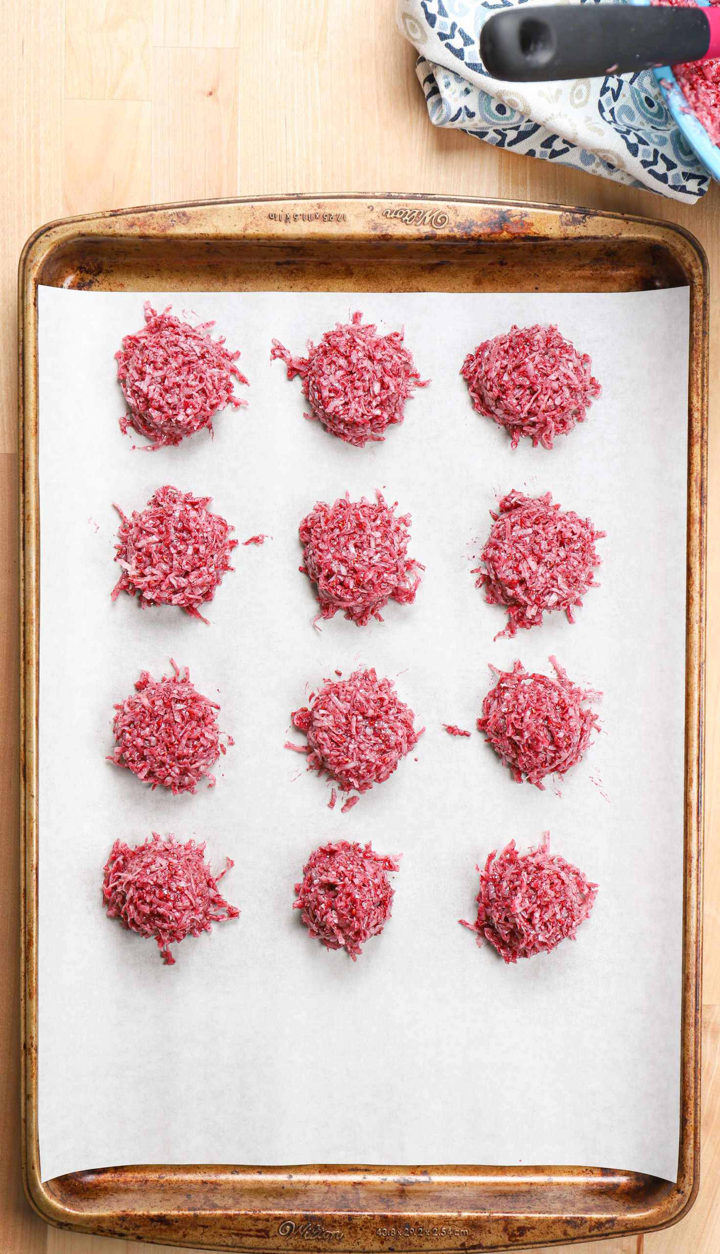 Overhead view of a batch of raspberry coconut macaroons right before baking.