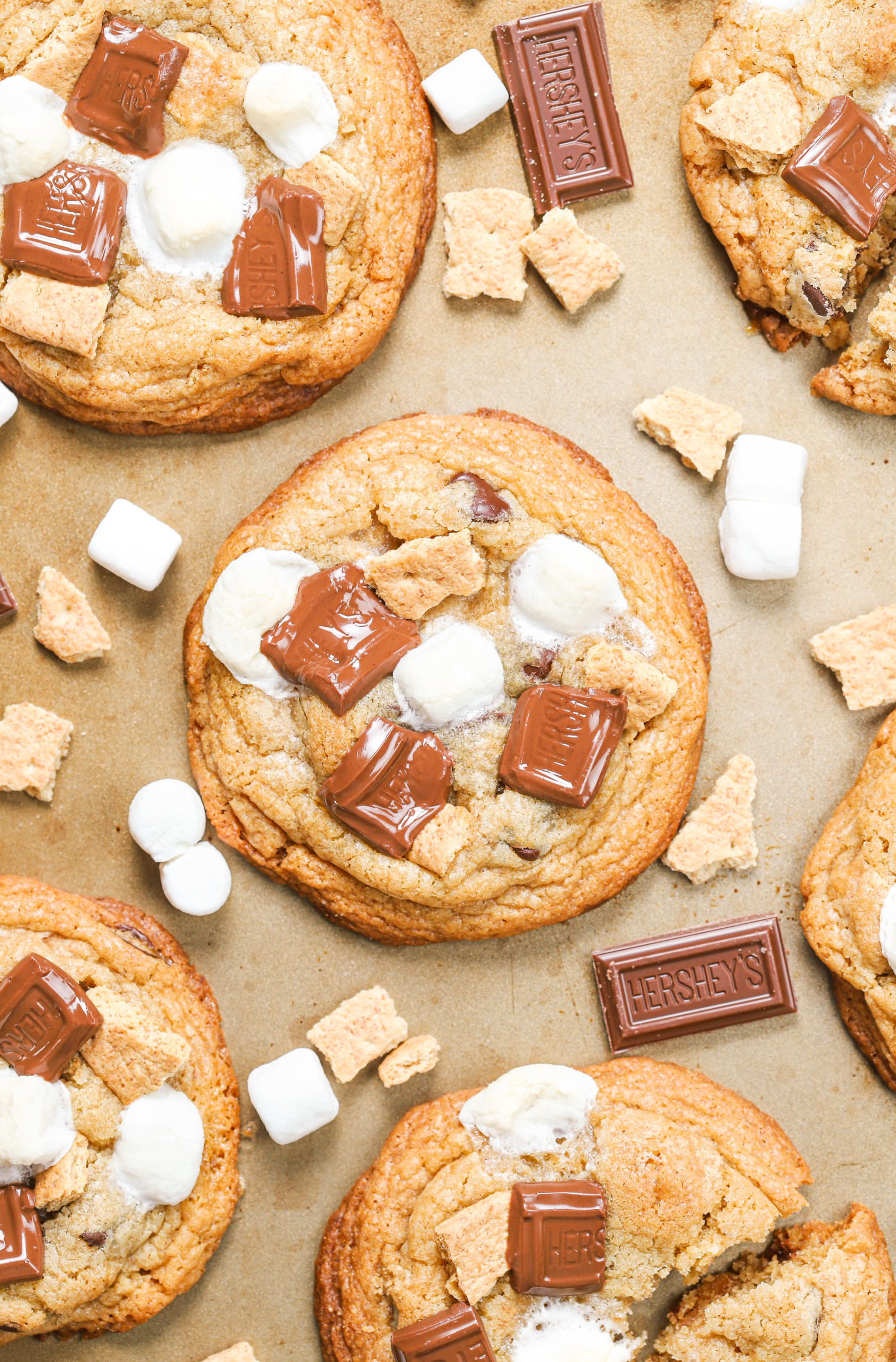 Up close overhead view of a chewy bakery style smores cookie on an aluminum baking sheet.