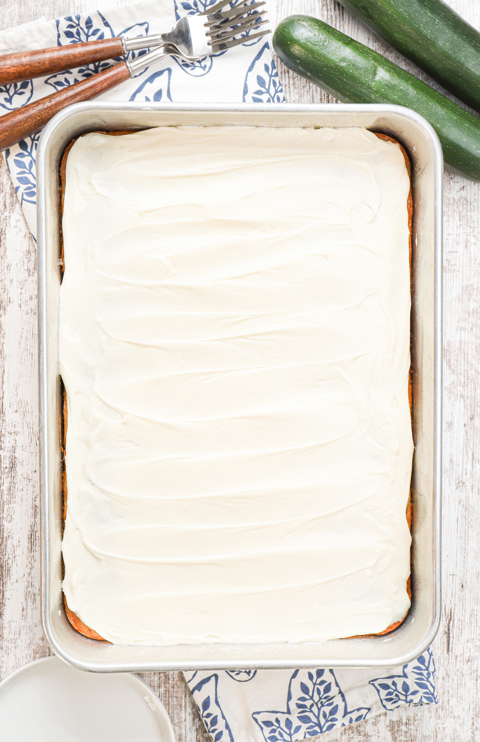 Overhead view of a pan of cream cheese frosted zucchini before cutting into pieces.